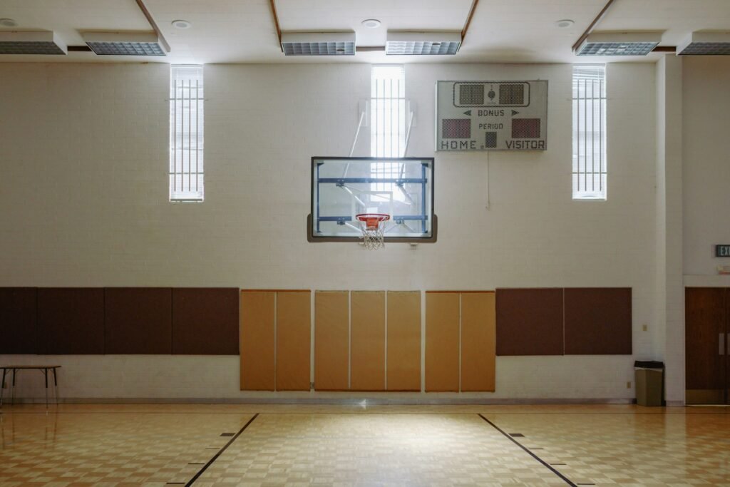 Indoor gym with a basketball hoop and scoreboard